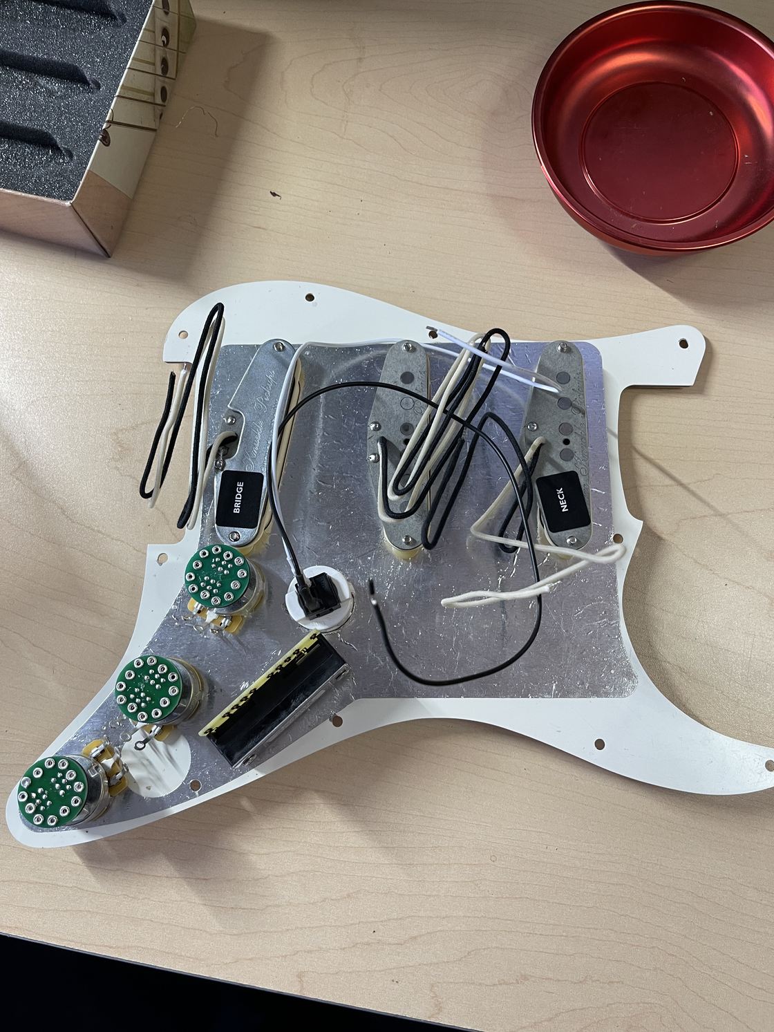 The pickguard removed, showing the shielding and switches.