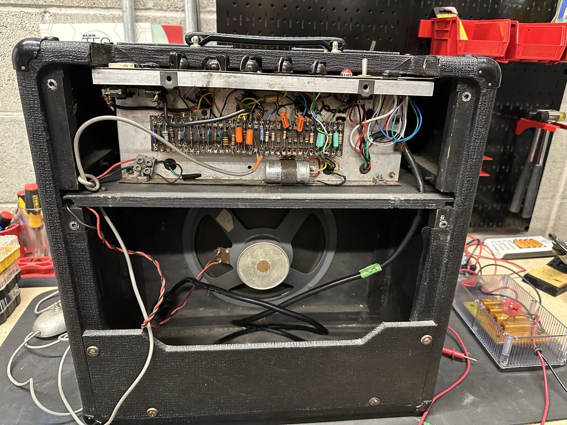 A vintage Vox AC10 amplifier opened for repair.